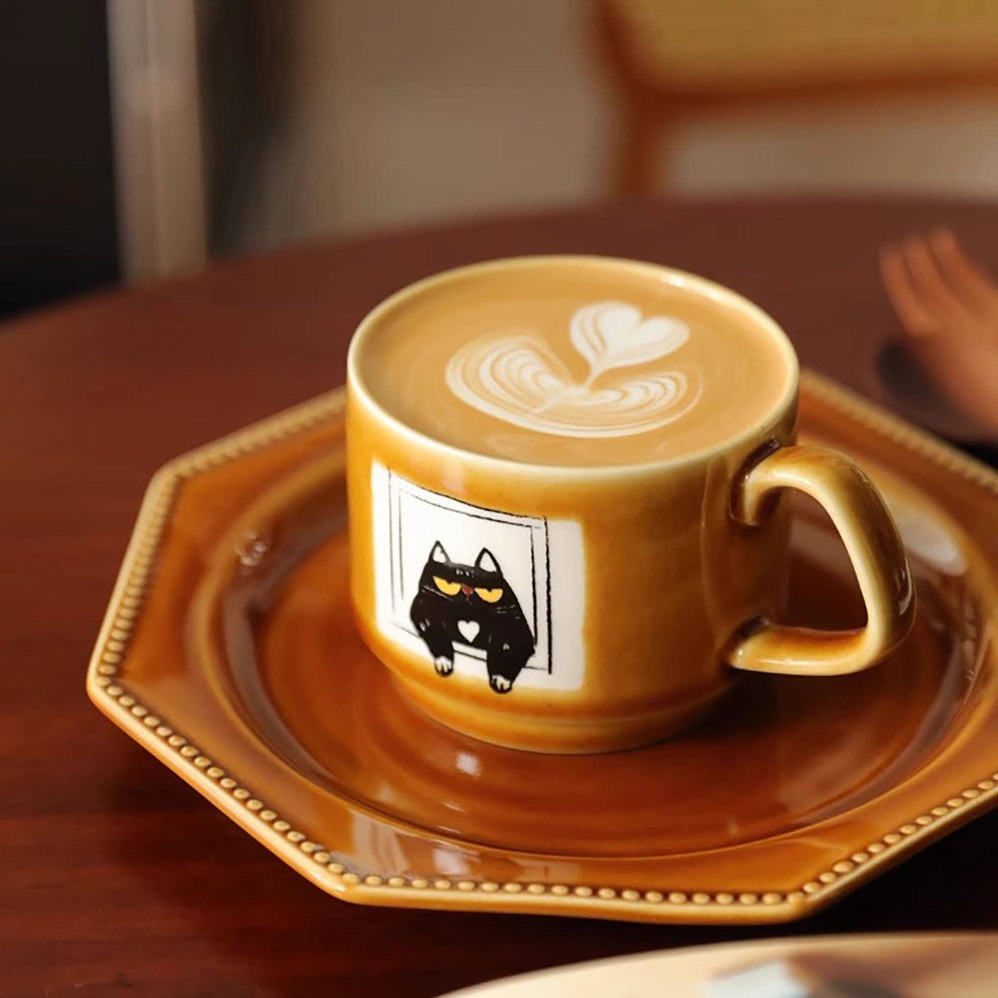 Ceramic coffee mug with cat illustration