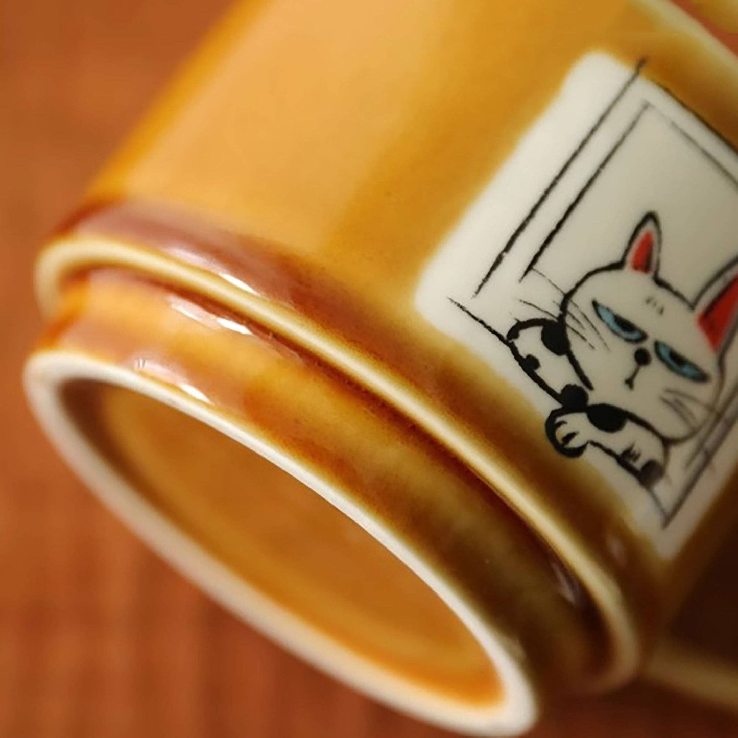 Ceramic coffee mug with cat illustration